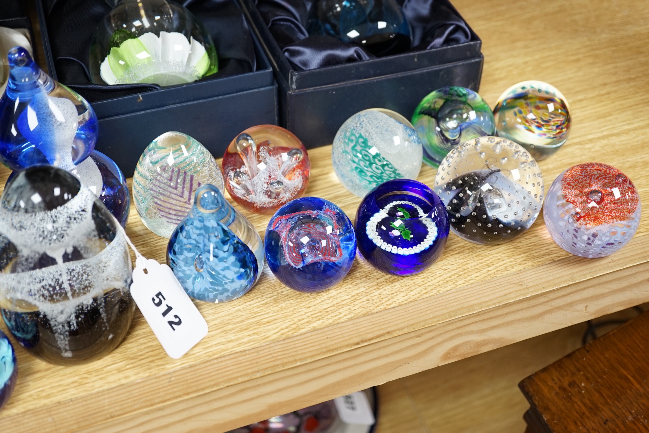 A collection of mostly Caithness glass paperweights, 1980s-2000s, with various boxes